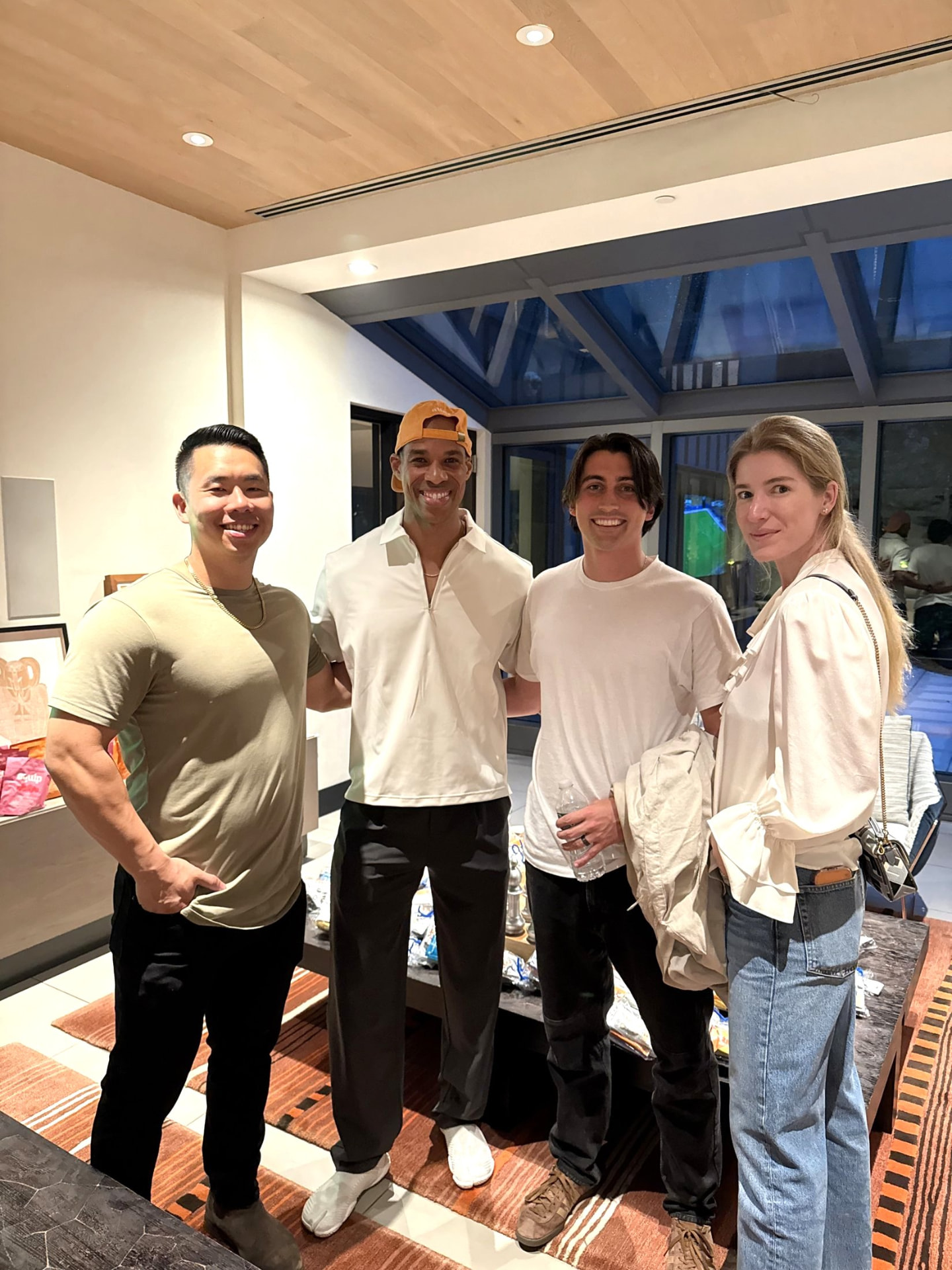Four members smiling together in the bright room at High Protein Night
