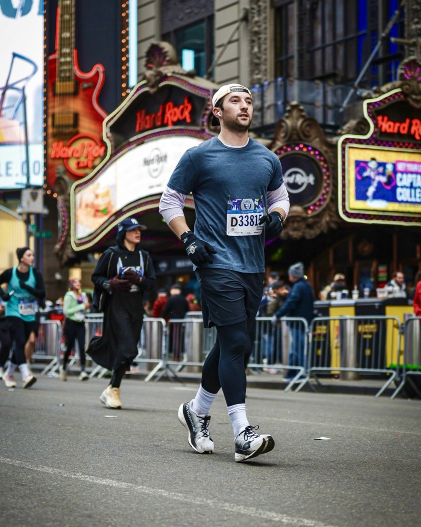 Adam running a race through Times Square in New York City