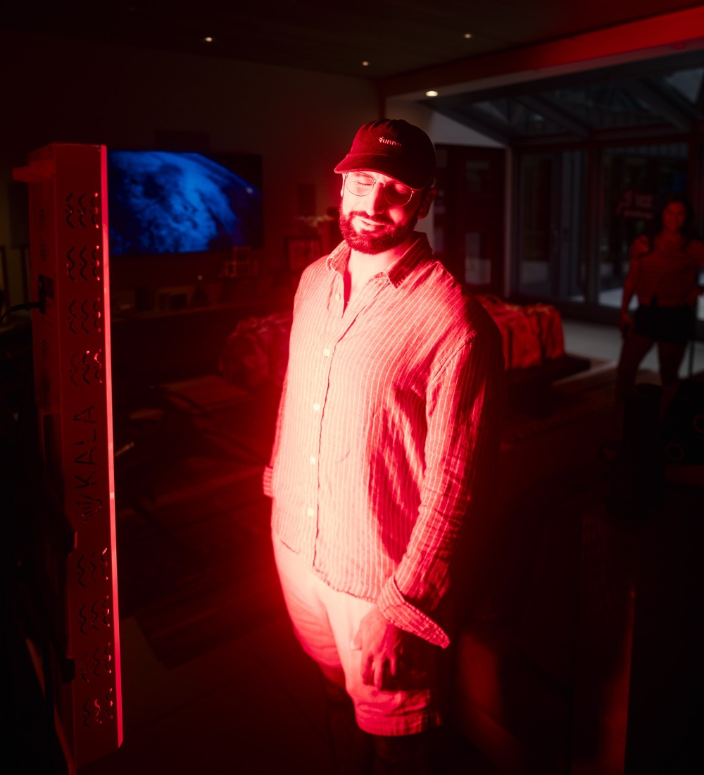 Adam using red-light therapy at an NYC Health Collective event